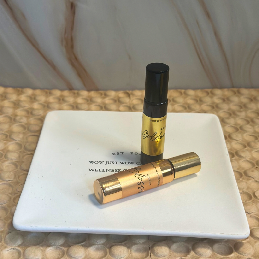 Two gold and black perfume bottles on a white square plate with a marble background.