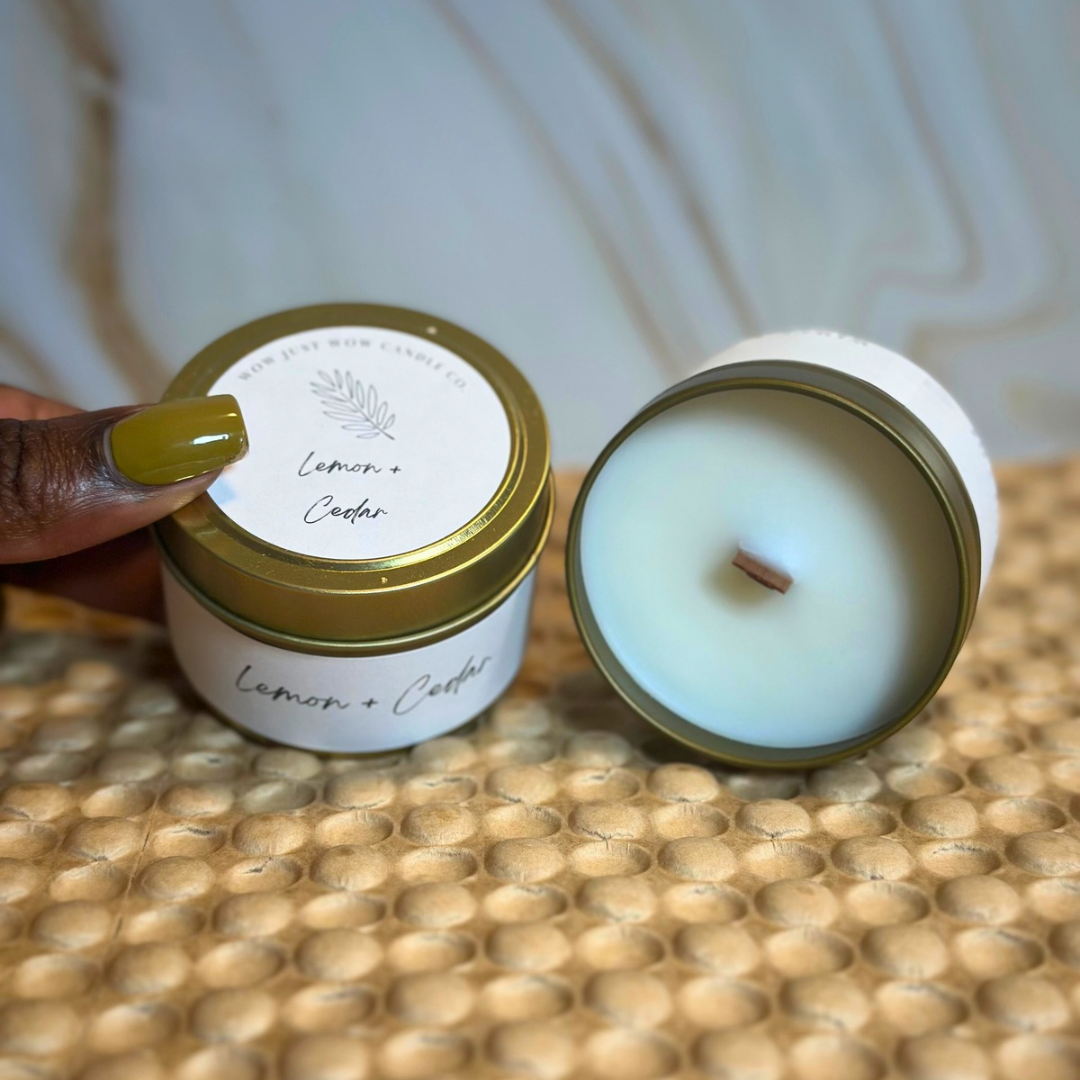 Open soy candle jar with creamy wax and small wick; gold lid and Lemon + Cedar label