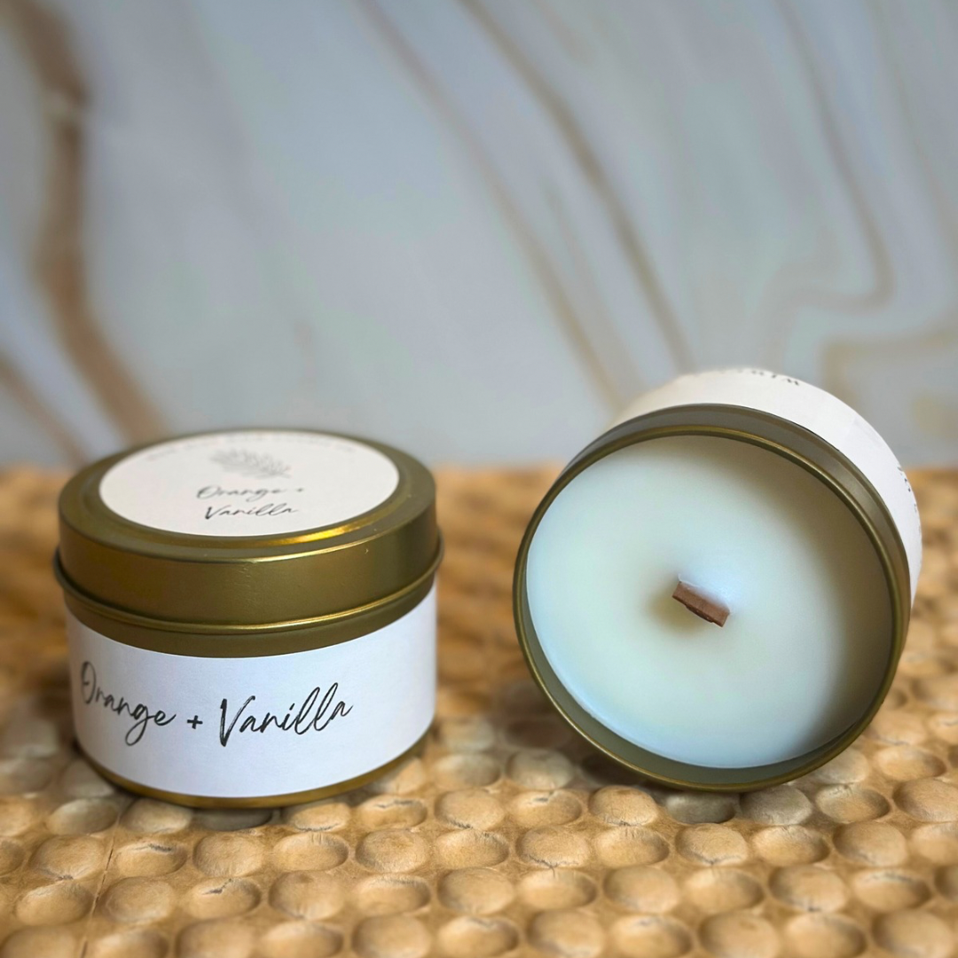 Soy candle tin with gold lid and orange vanilla label; soy candle top close view, unlit