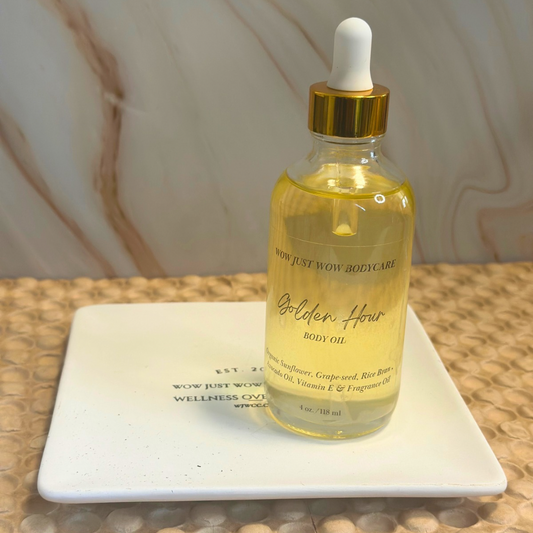 Bottle of 'Golden Hour' body oil with a dropper on a marble surface. Organic Body Oil (Golden Hour): Nut-free Cocoa Butter Cashmere body oil for deep hydration and a golden glow.