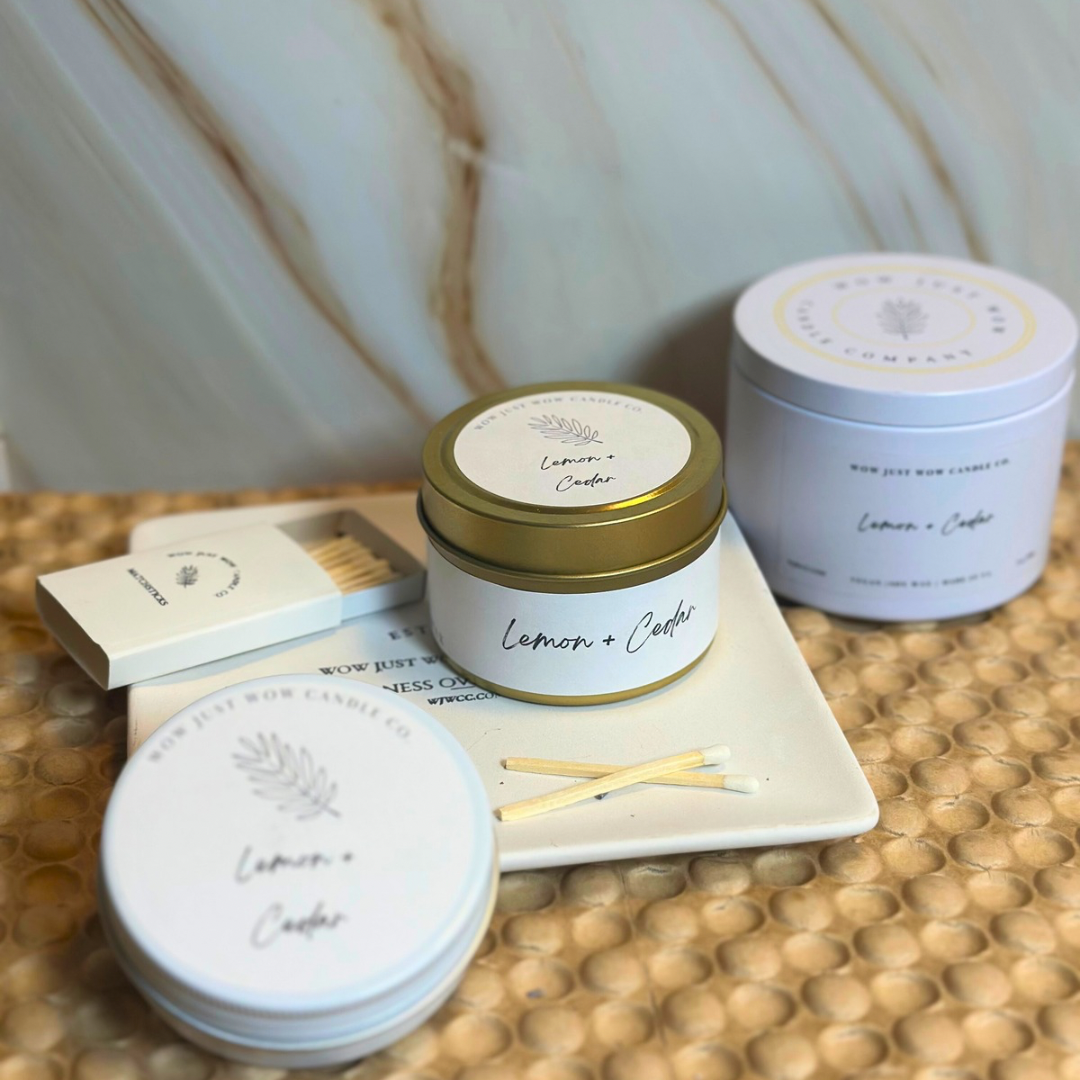 Soy candle set with gold and light-blue jars, labeled Lemon + Cedar; matchsticks included