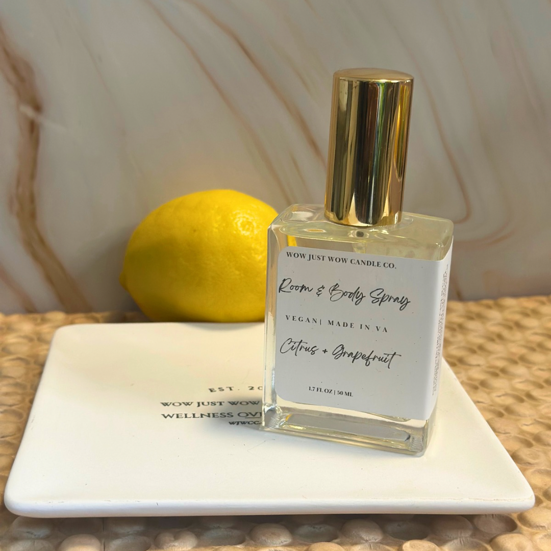 Room & Body Spray bottle with gold cap and lemon on a marble slab