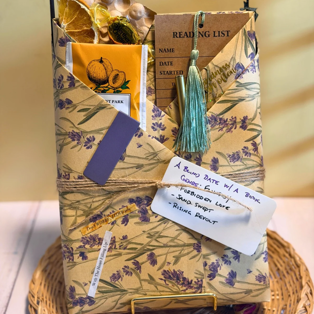 Gift basket with lavender-themed packaging, books, and decorative items on a neutral background.