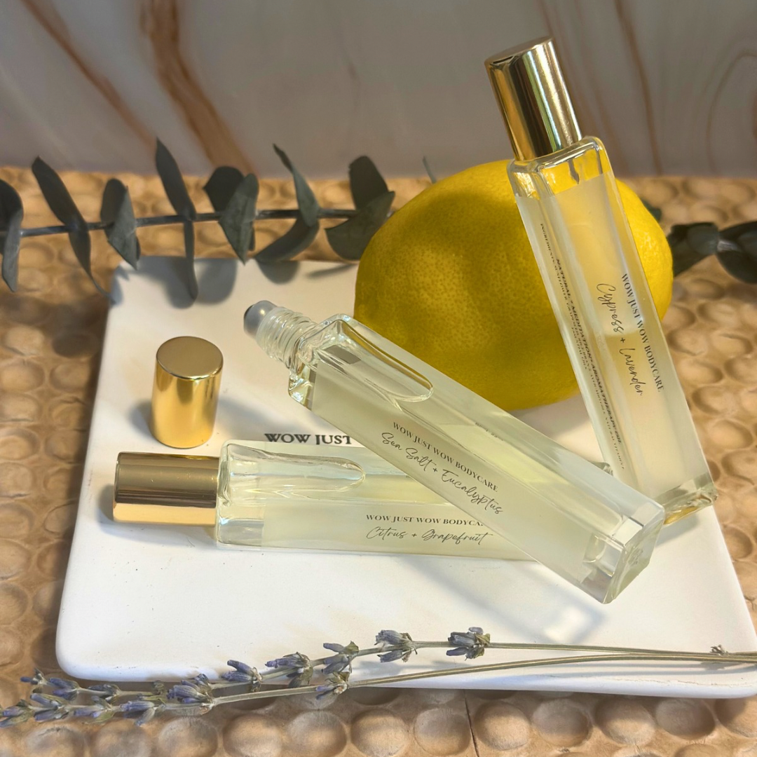 Perfume bottles on a white tray with a lemon and lavender sprigs.