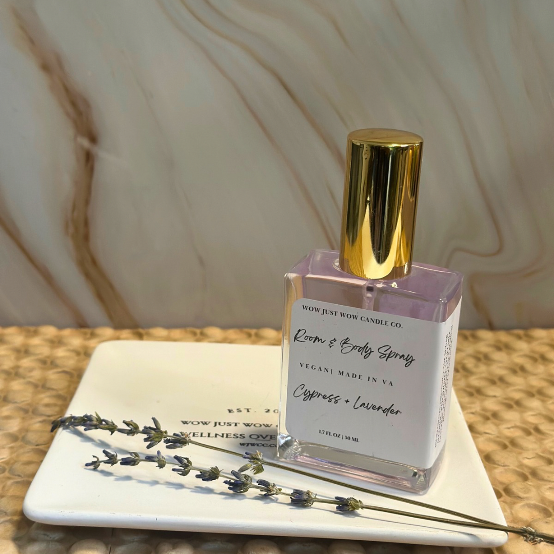 Room & Body Spray bottle with gold cap on a marble surface with lavender sprigs